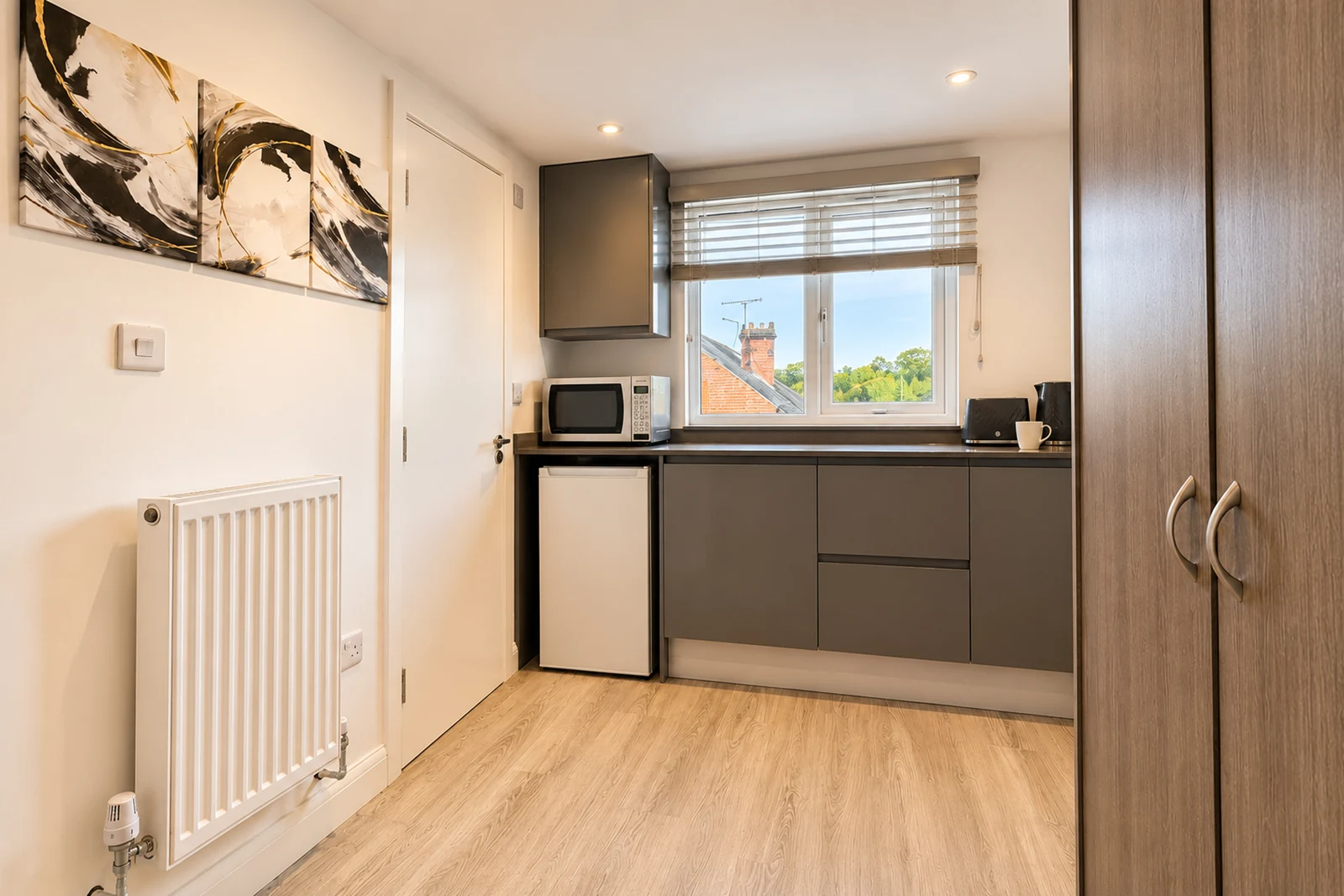 Room 5’s kitchenette and wardrobe, with room to unpack and settle in.